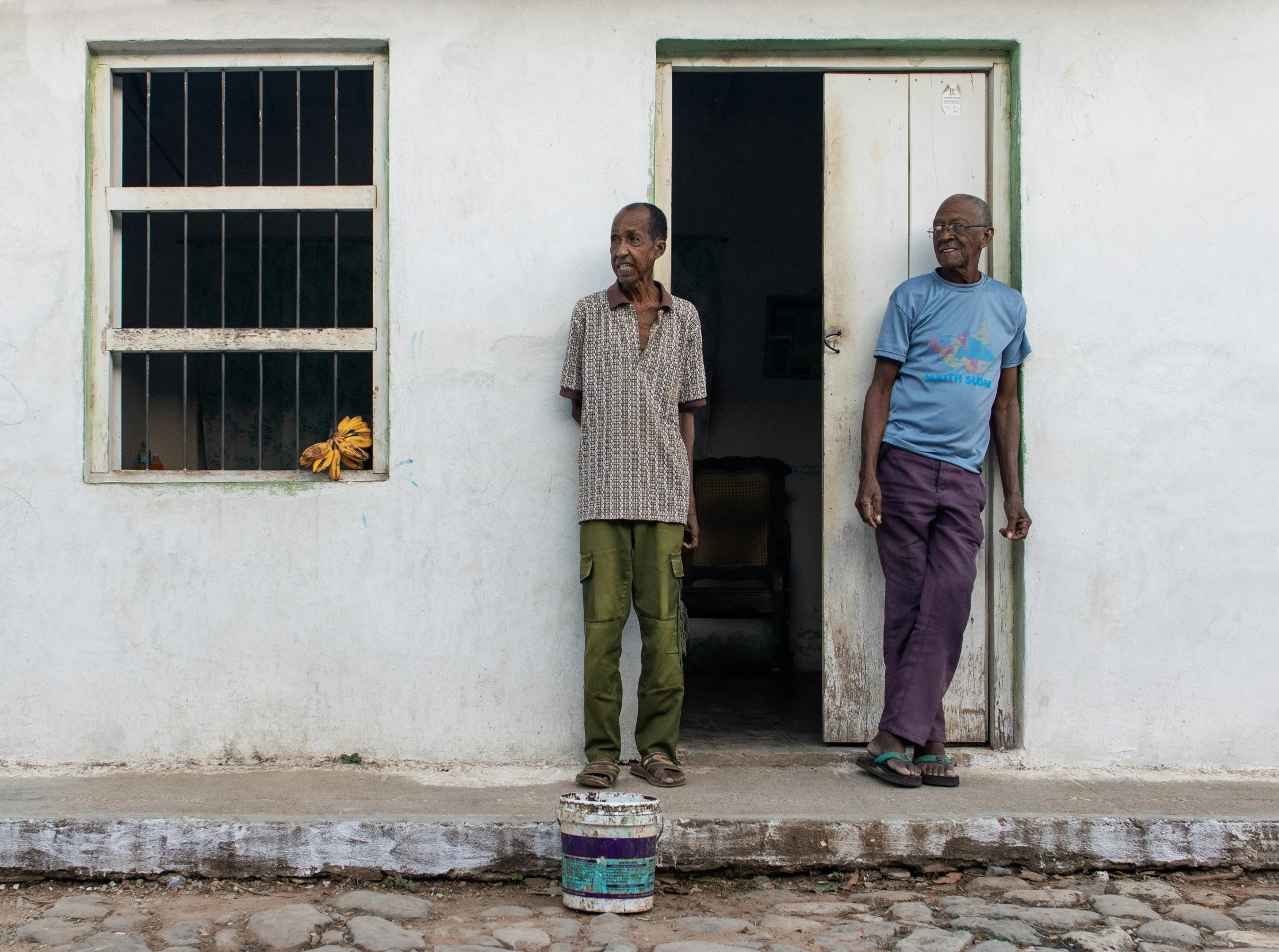 two men stand on either side of the door