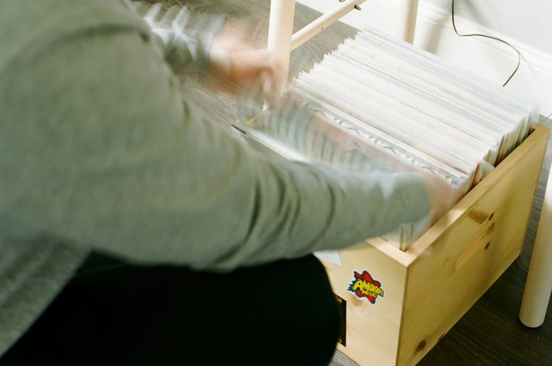 a woman weaving yarn on top of a wooden bench