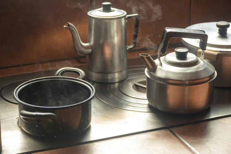 a tea kettle and tea pot on the stove