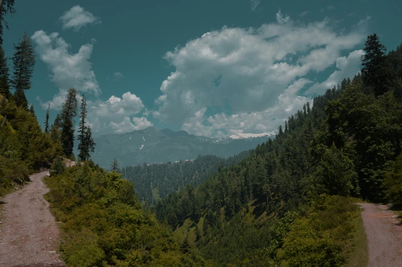 a scenic po of a road with a mountain view in the background