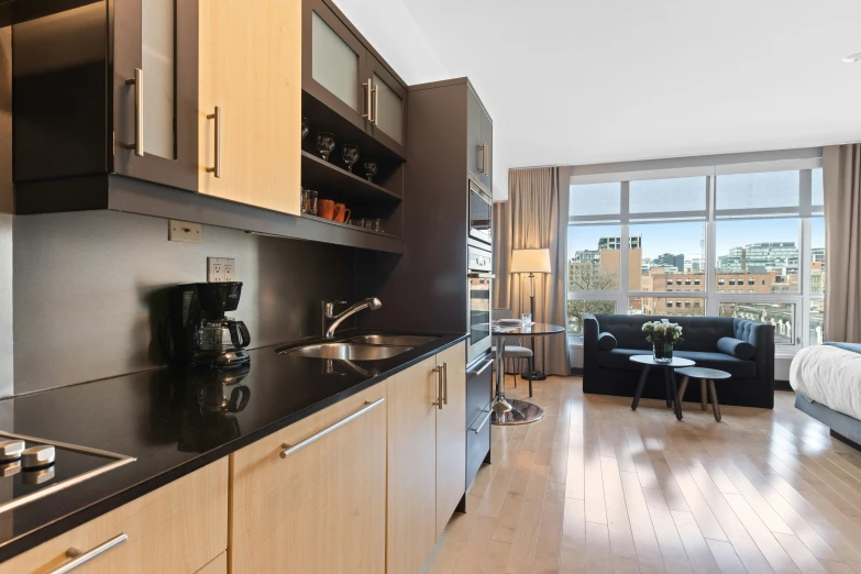 a modern looking apartment kitchen with wooden cabinets