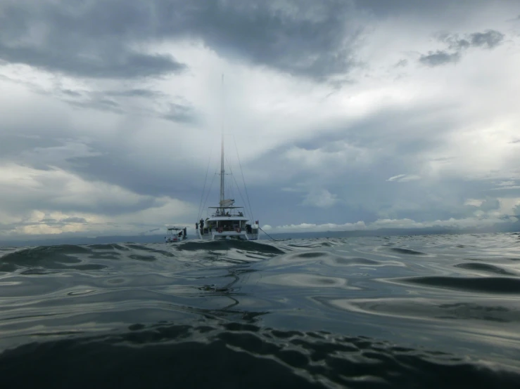 a boat is floating under an ominous sky