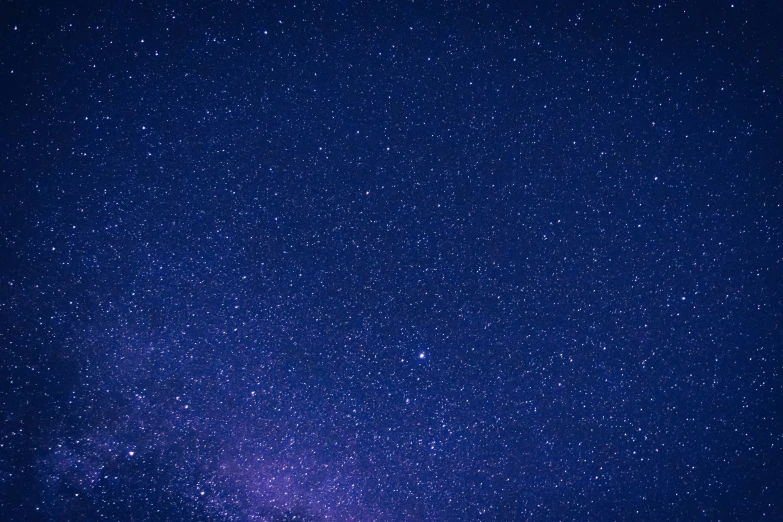 dark blue sky filled with stars and a bright purple center