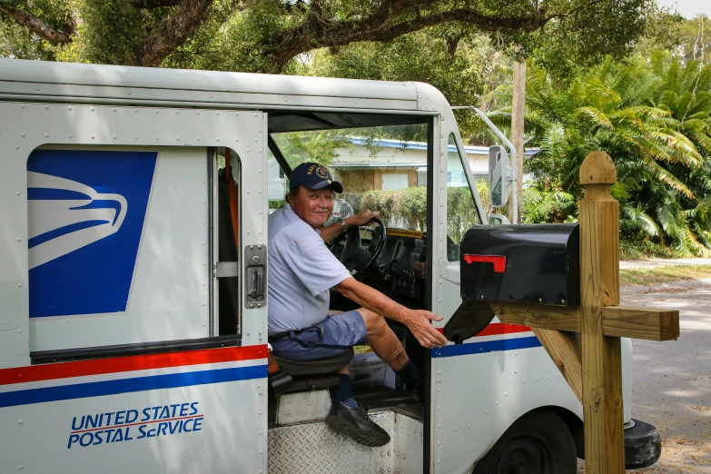 a mailbox driver smiling for the camera