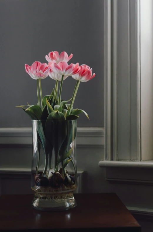 a vase with many flowers in it sitting on a table