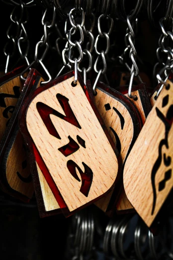 some wood dices sitting on some chains