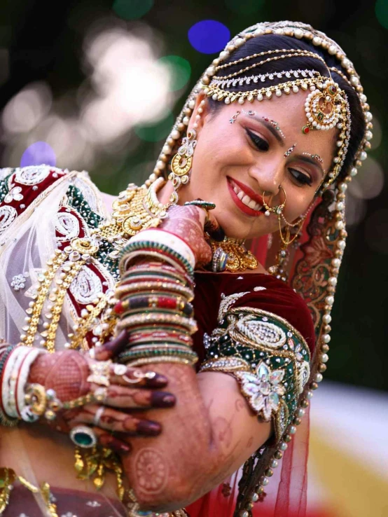 woman in bridal jewelry smiling at camera