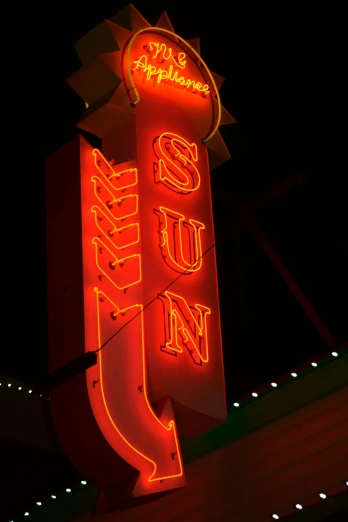 a lighted neon sign advertising a city