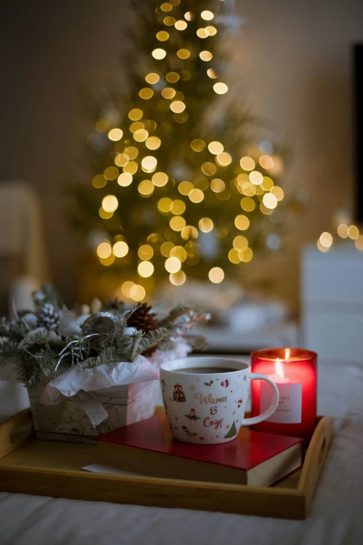 a candle is sitting on a tray next to some presents