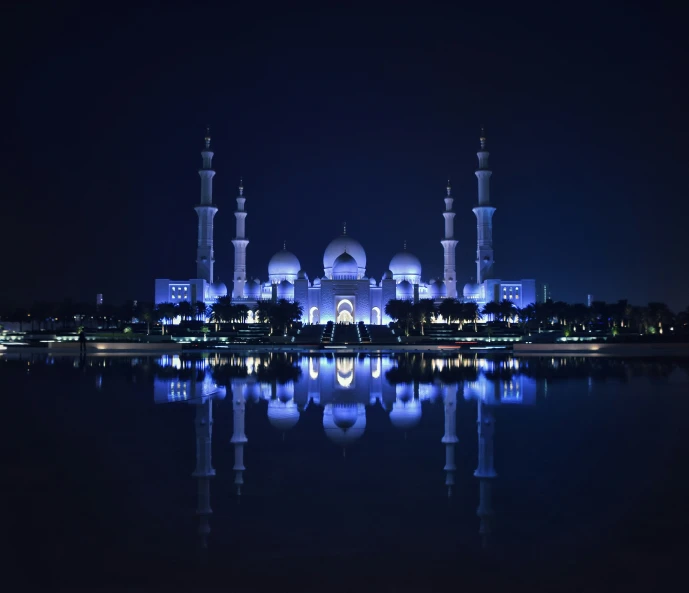 a view of a building on the water at night