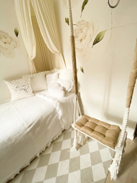 white canopy bed with flower on the wall