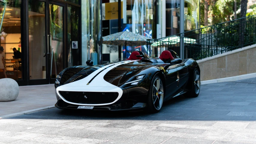 a sports car in a city near buildings