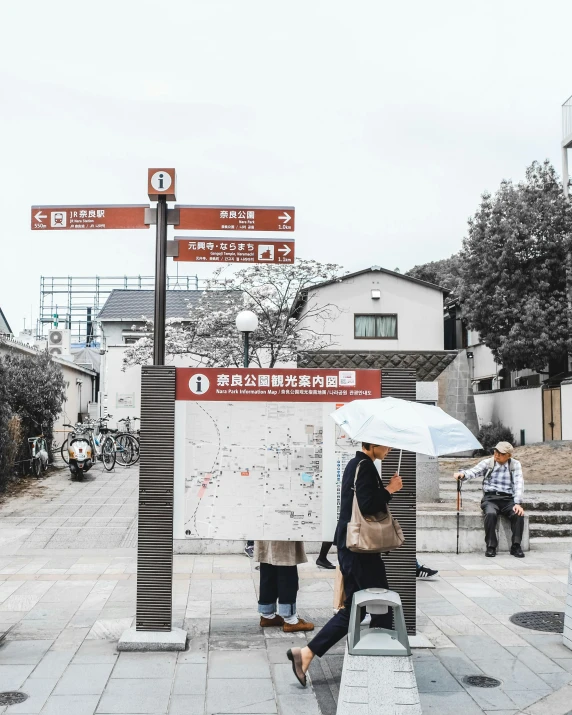 a group of people walking with an umbrella