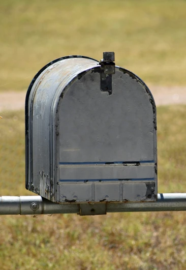 a mail box with an empty flap is in a park