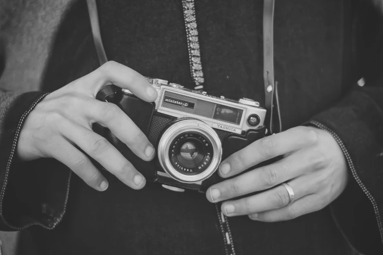 the woman is holding the old camera in her hands