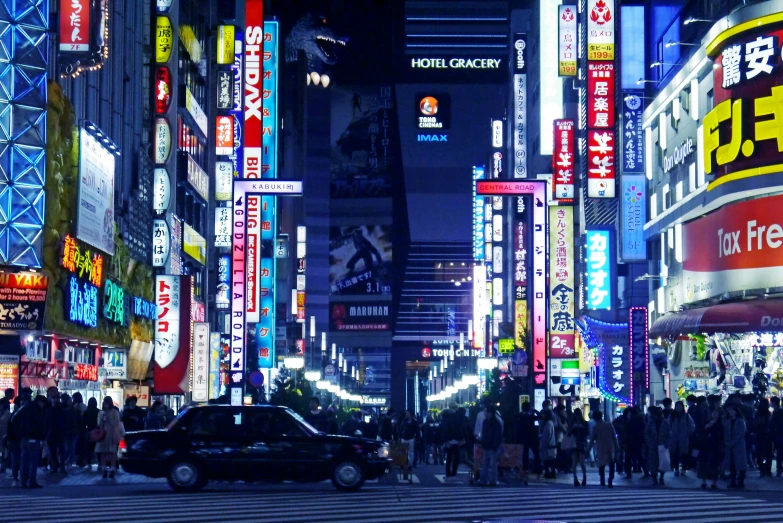 a night scene with people and cars in the city