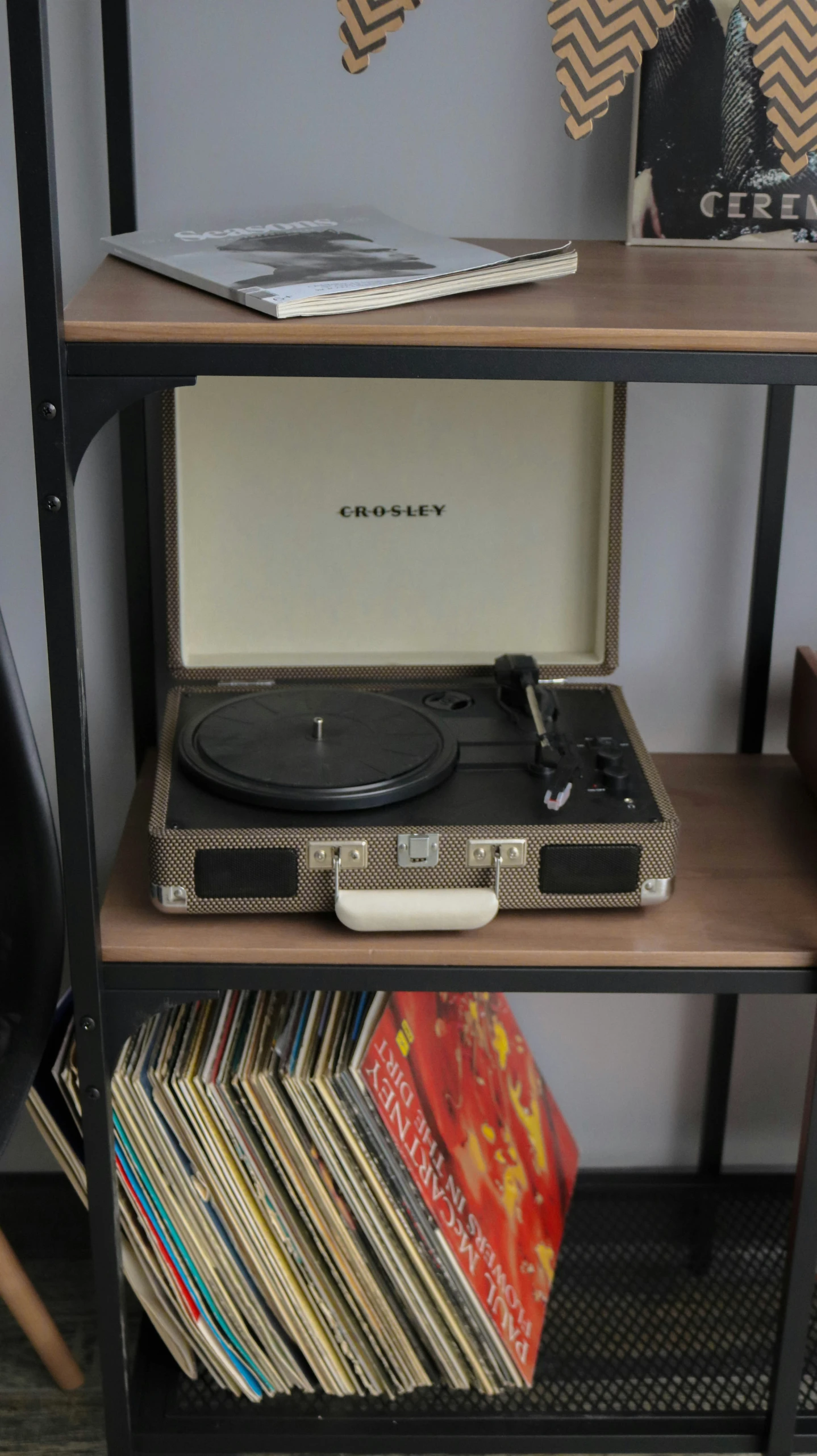 an old record player on a shelf full of records