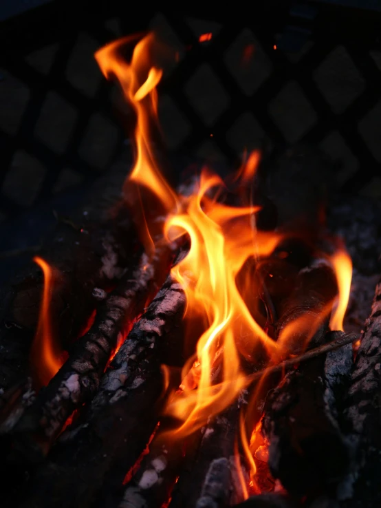 close up view of the flames of a large outdoor grill