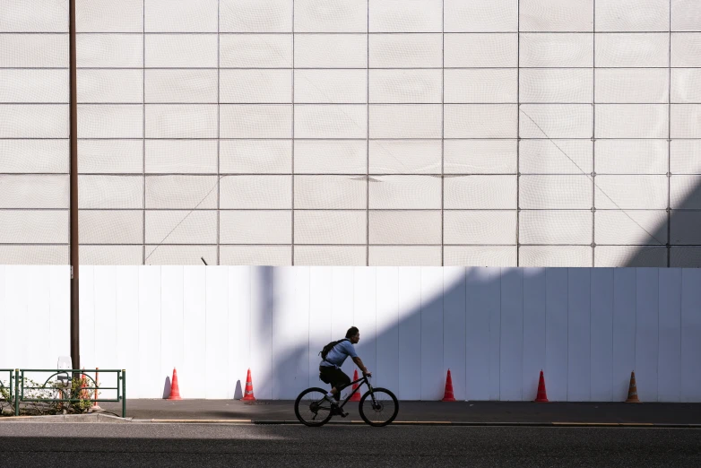 a man rides his bicycle down a street