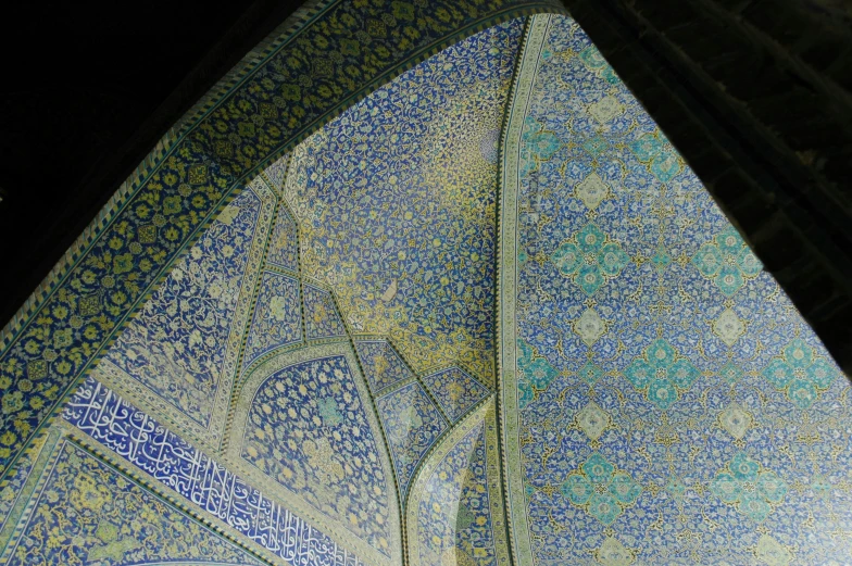 close up view of blue and green mosaic on the wall