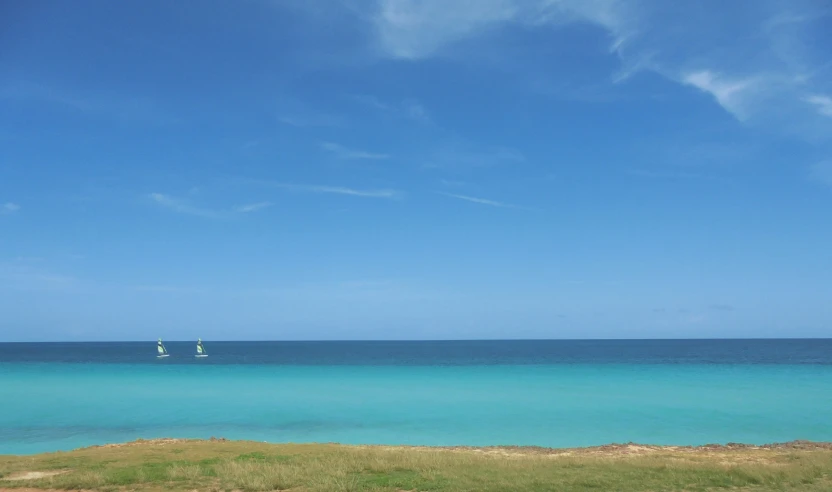 some sail boats out on the water with no people