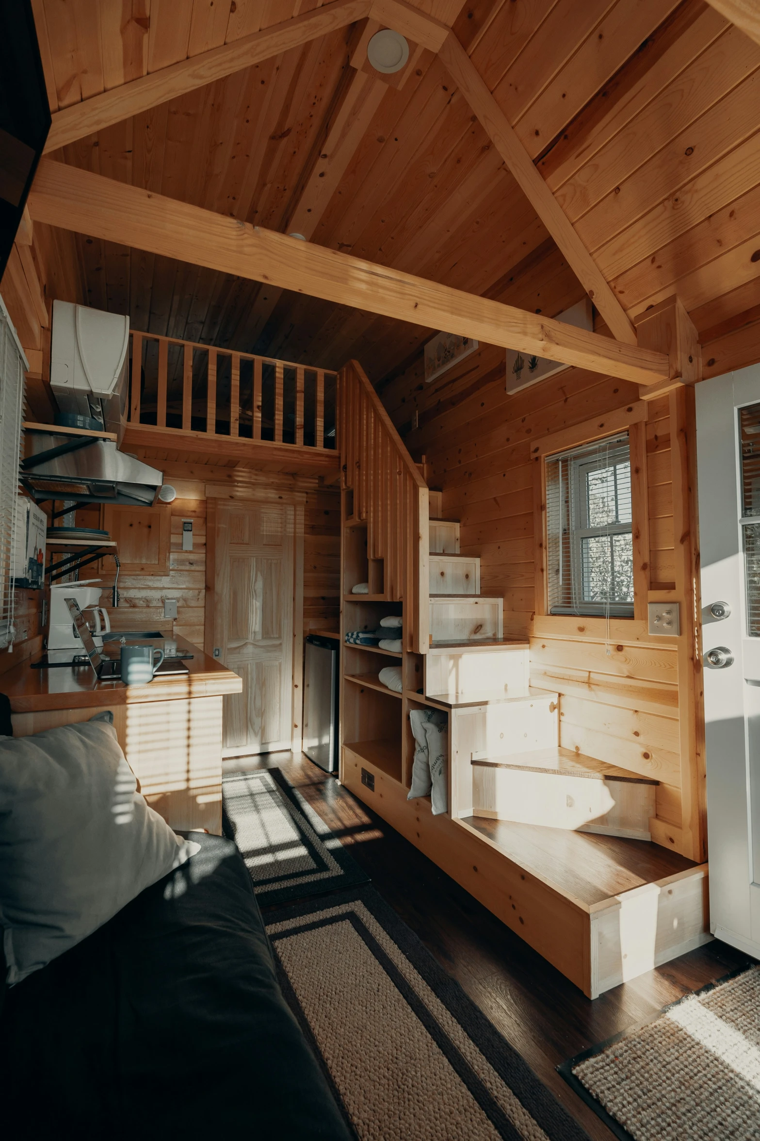 a living area with wood paneling and stairs