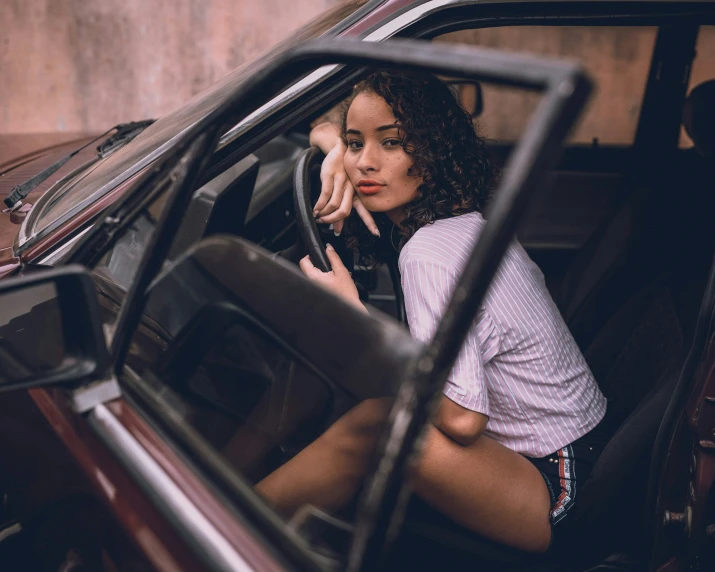 a woman that is sitting inside of a car