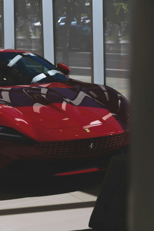 the red sports car is parked on the side of the road