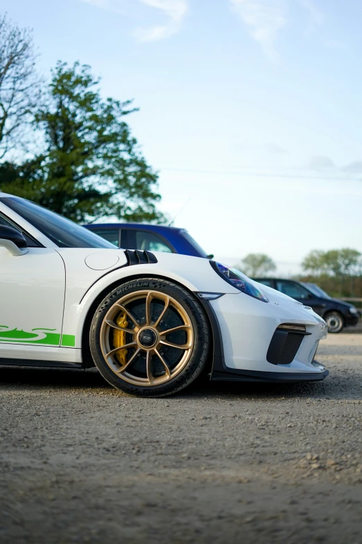 two white sports cars on the road