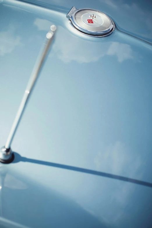 the rear end of an old car is shown with a clock displayed