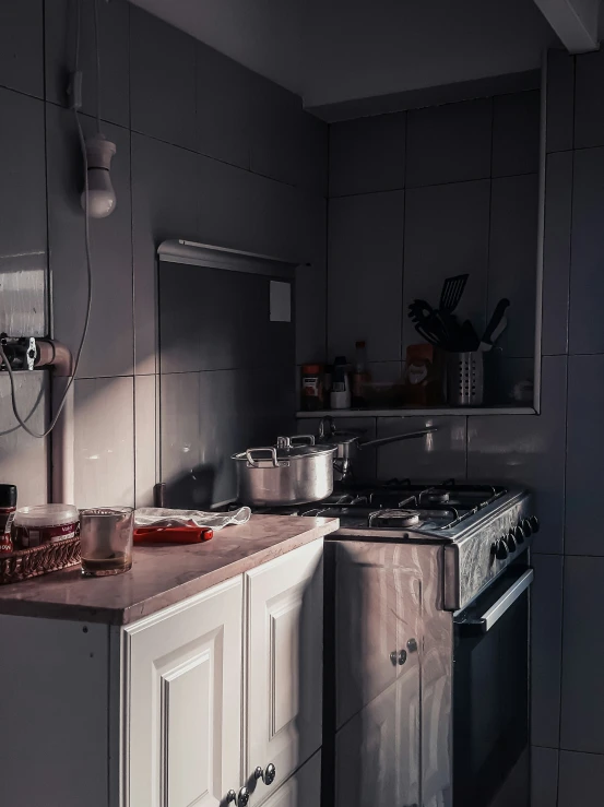 a kitchen is shown with a stove and cabinets