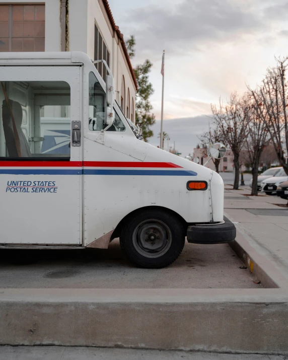 a white delivery truck sitting in front of a building