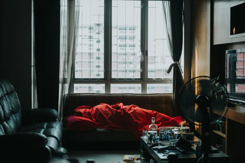 a living room with a couch, tv and a window