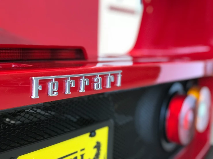 the front end of a red sports car with its license plate on