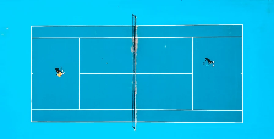 tennis players playing tennis on the court in competition