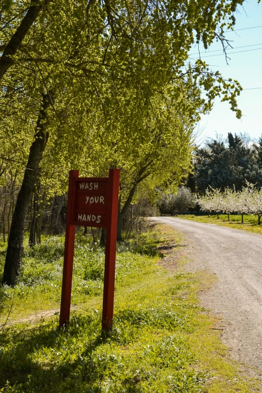 a road sign sits at the entrance to a field