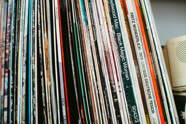 a lot of record players stacked on a shelf