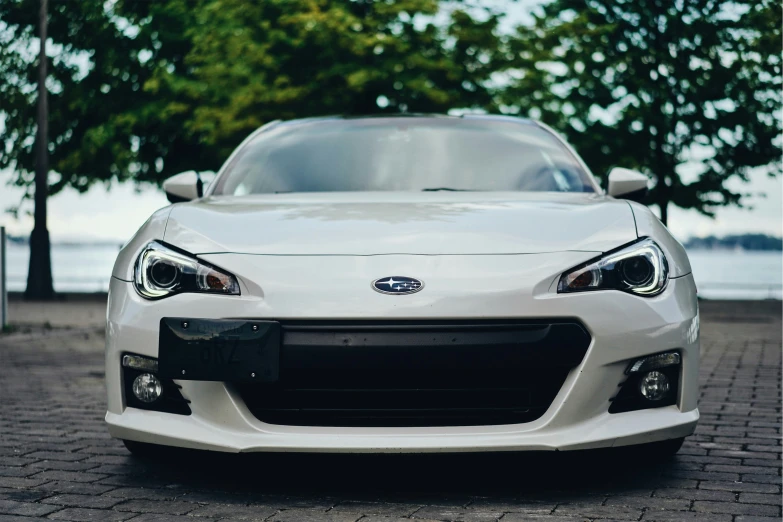 a close up of the front of a white sports car