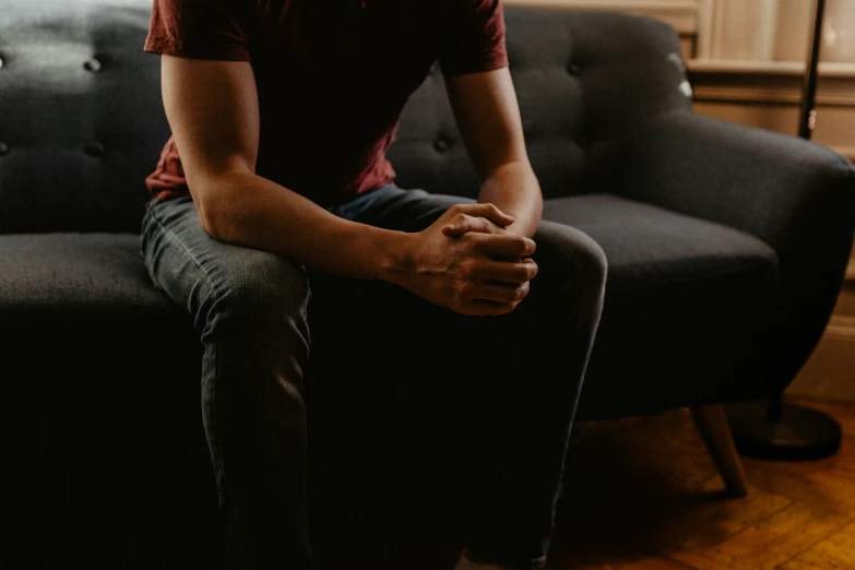 a person sitting on a couch and waiting