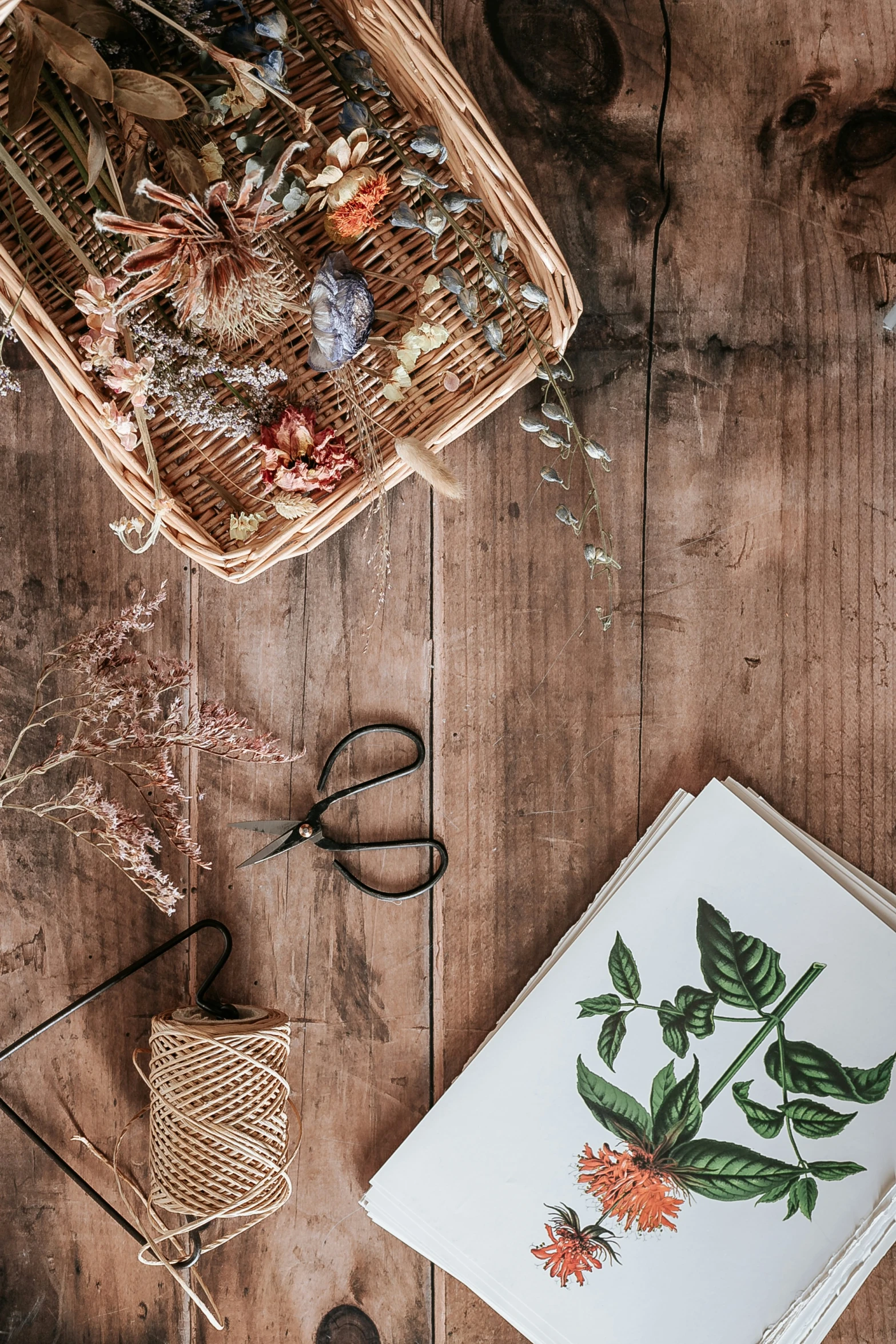 a wooden table topped with paper and some type of crafts