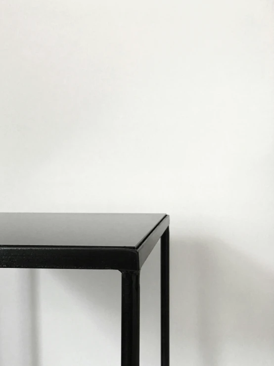 black desk sitting on top of white wall