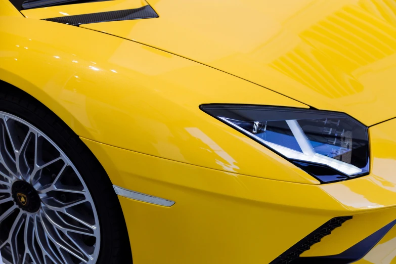 yellow sports car parked on the side of a street