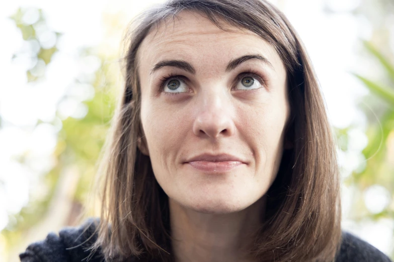 a woman with a brown shoulder length haircut with a flower in the middle