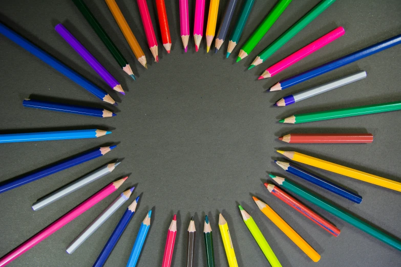 many colorful crayons arranged in a circle with the ones showing