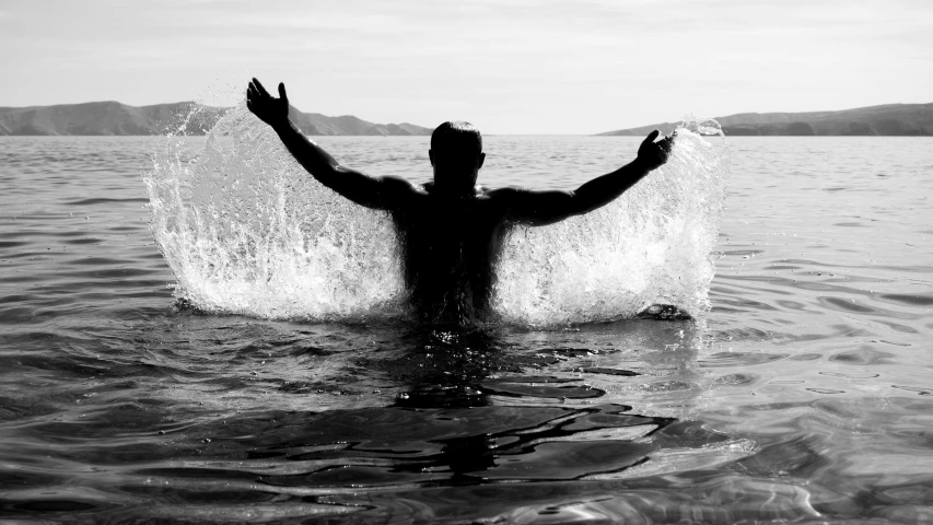 a person in the water about to jump into the ocean