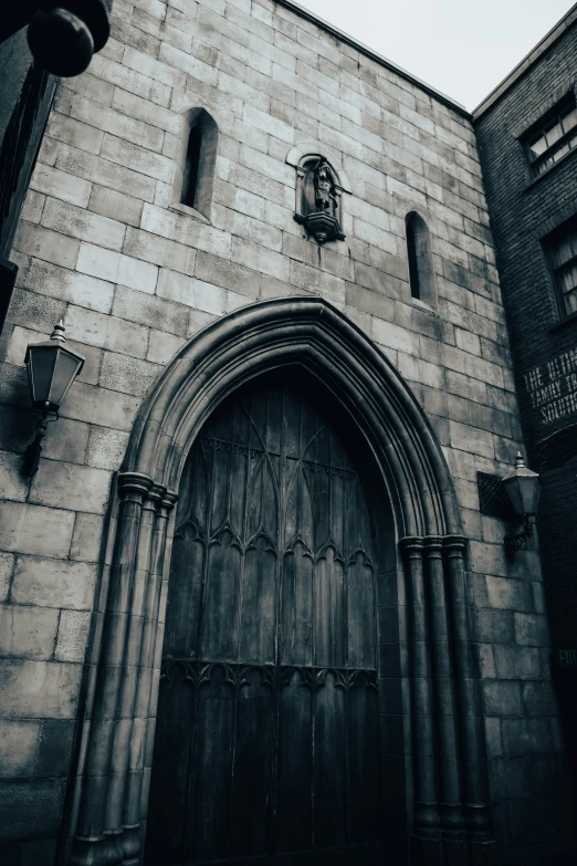 a large door to an old building with a clock on it