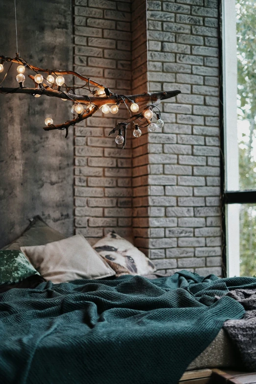 a bed and table in a room with brick walls