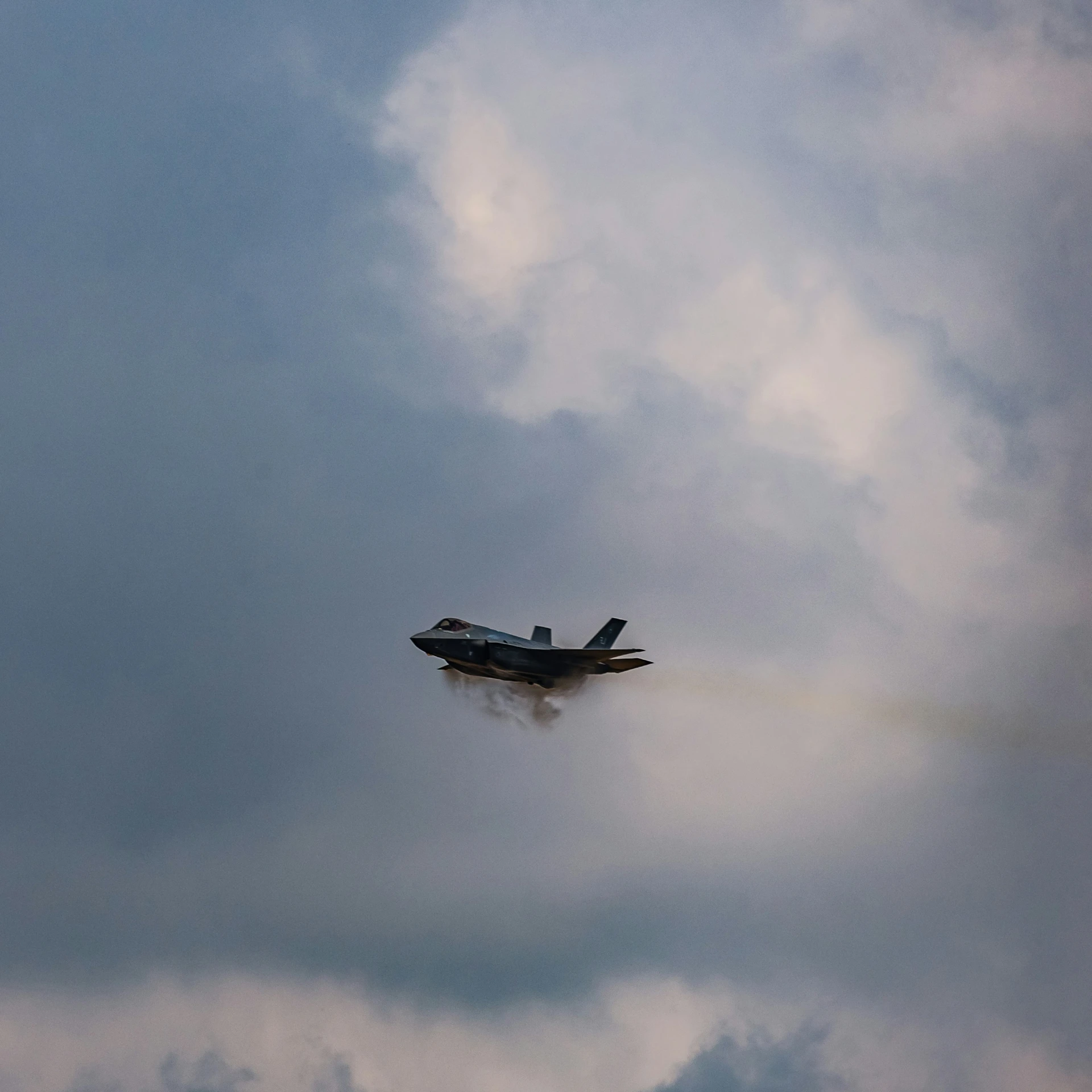 an airplane with smoke coming from it and flying through the sky