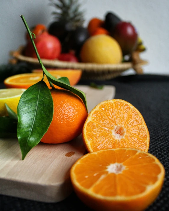 a wooden  board topped with orange slices and fruit