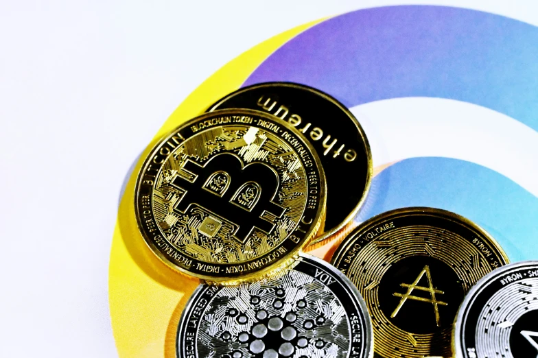 a pile of bitcoins sitting on top of a yellow and blue striped table